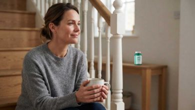 Upper abdominal bloating: a woman sitting on her stairs with a mug, resting a moment