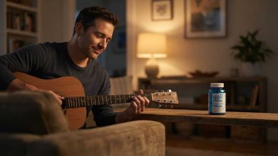 Best ashwagandha: a man tuning an acoustic guitar in his living room at dusk