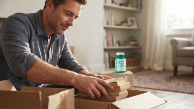 Prebiotics and probiotics supplements: a man kneeling to sort books into boxes on the floor
