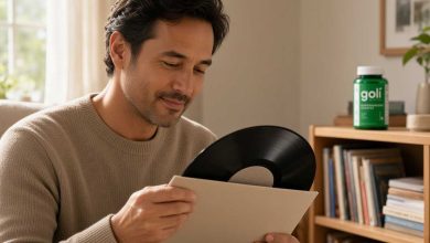 Greens gummies vs powder: man checking a vinyl record beside its plain sleeve at home