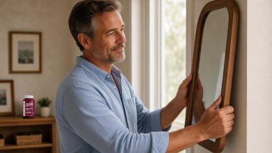 Nitric oxide supplements: a man in his fifties hanging a mirror on a hallway wall